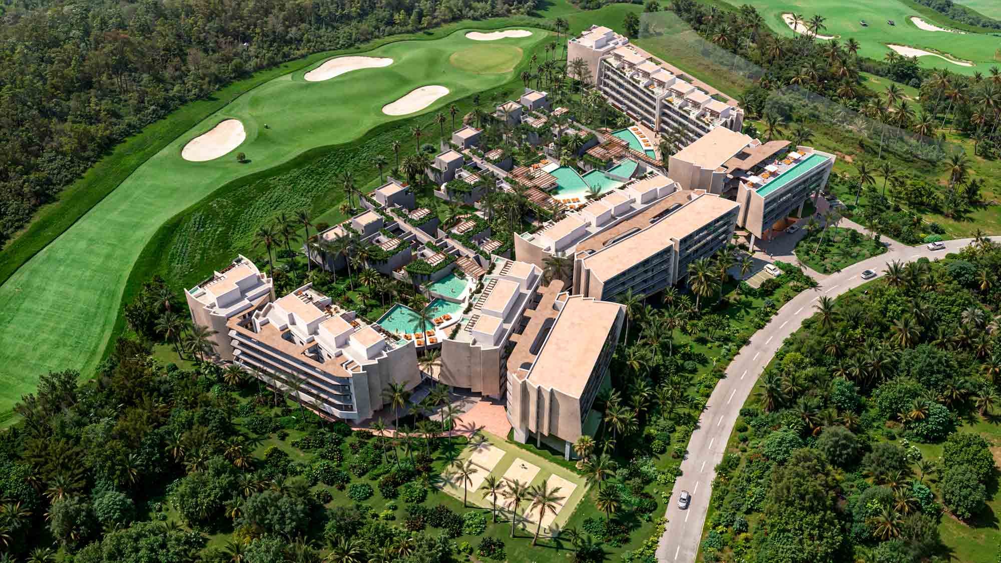 Aerial rendering of Andara Cap Cana: the mid-rise residence blocks and the row of golf-front townhomes that together make up its 175 homes.